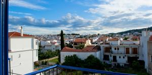 a view of a city from a balcony at Syraina Apartments in Skiathos