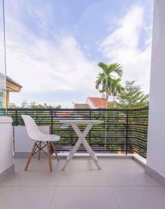 a white table and a chair on a balcony at HOI AN Meditation-2bed near old town in Hoi An