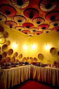 a room with a bunch of umbrellas on the wall at Le Luxe Boutique Hotel in Ban Nongdouang