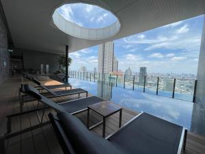 a building with a pool with a view of a city at Private room with 1 Bedroom & 1 Bathroom, near BTS Surasak in Bangkok