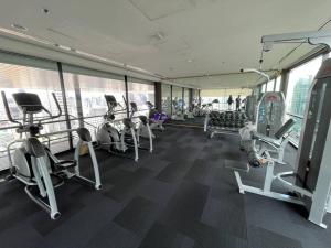 a gym with treadmills and machines in a building at Private room with 1 Bedroom & 1 Bathroom, near BTS Surasak in Bangkok