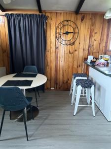 een keuken met 2 tafels en stoelen en een aanrecht bij Sister’s place in Auckland