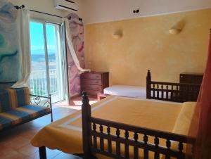 a bedroom with a bed and a large window at Ciuci's Manor in Aragona