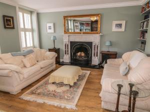 a living room with two couches and a fireplace at The River House in Ramelton