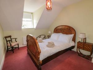 a bedroom with a bed with two towels on it at The River House in Ramelton