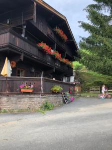 a girl riding a bike in front of a building at Hinterfoisching - Chalet nahe Kitzbühel in Westendorf