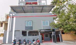 a group of motorcycles parked in front of a building at Townhouse RCC Sunrise in Ameerpet