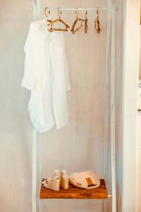 a shelf with a white shirt and shoes on it at Kyparissi Country House in Marmaroto +25 photos