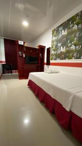 a room with a large bed with a white and red table at DESTINY's PLACE HOTEL CHEAPEST! COLDEST! MAGANDA! MALINIS! NEAR ROBINSONS XENTRO MALL in Calapan