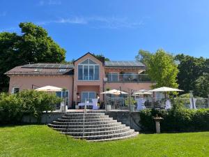 a house with a set of stairs in the grass at Schöne Aussicht in Alzenau in Unterfranken