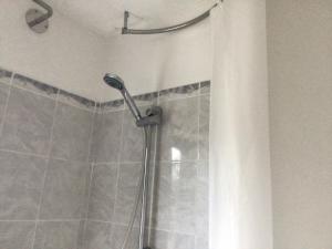 a shower in a bathroom with a shower curtain at Cool and cosy in Brandon