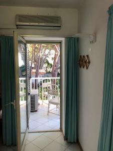 an open door to a patio with green curtains at Mondello room Pan in Mondello