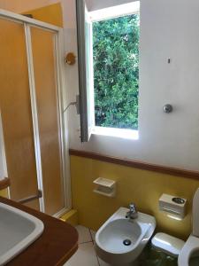 a bathroom with a sink and a window at Mondello room Pan in Mondello