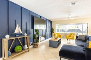 a living room with blue walls and yellow chairs at Spacious 4 Bedroom 3 Bathroom House with Heated Pool and Outdoor Shower close to FFL Airport and Cruise Port in Plantation