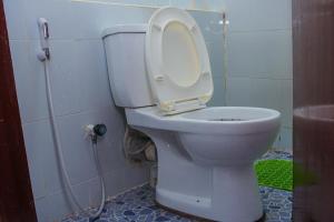 a toilet with the seat up in a bathroom at Joyous Homes in Mombasa +7 photos