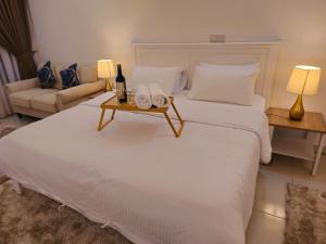 een slaapkamer met een groot wit bed en een bank bij 1 Dream Home @ Tiara Imperio Studio 外国4星级酒店风格与浪漫环境 in Bangi