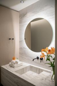 a bathroom with a large mirror and a sink at Ares Luxurious Residence in Kolymvari