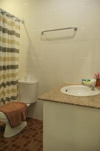 a bathroom with a sink and a toilet and a shower at Krabi Pitta House in Krabi