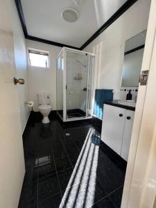 a bathroom with a toilet and a glass shower at Tupper Retreat in Boulder