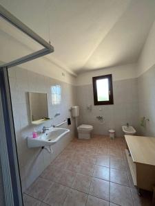 a bathroom with a sink and a toilet at La Corte Degli Ulivi in Cardedu