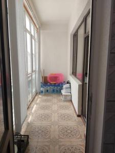 a hallway with a room with a table and a chair at ELSAR guesthouse in Osh