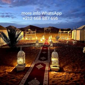 a set up for a wedding in the desert at night at Ahlam Luxury Camp in Merzouga