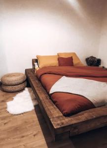 a bedroom with a bed made out of a wooden frame at Appartement Spacieux au Pays du Mont-Blanc in Sallanches