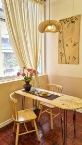 a dining room with a table and chairs and a window at DAISY'S STAY in Hanoi