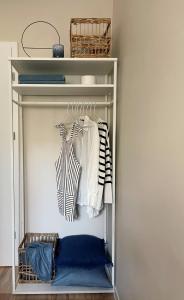 a white closet with clothes hanging in it at Powder Blue Studio in Gdańsk