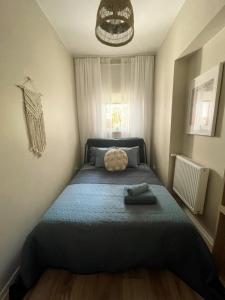 a bedroom with a bed with a blue blanket at Powder Blue Studio in Gdańsk