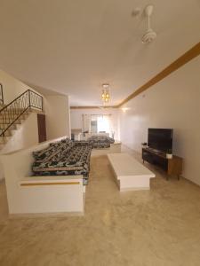 a living room with a stove and a tv at Linda's Little Lincoln in Watamu