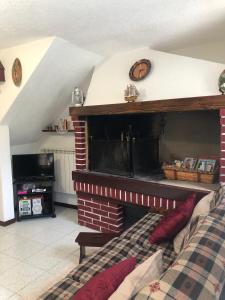 a living room with a fireplace and a bed at Haus Granata Family - Trekking - Bike in Giazza
