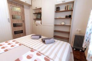 a bedroom with a large bed with two pillows on it at Top Center Relax, NDK & Vitoshka str, FREE Secured parking in Sofia