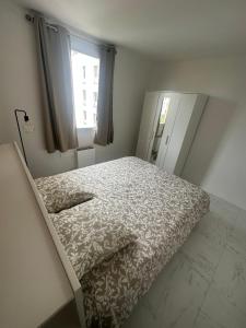 a bedroom with a bed and a window at 5 minutes à Pied du Stade De France in Saint-Denis