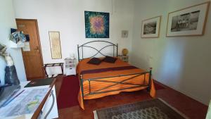 a bedroom with a bed and a desk in it at Butterfly B&B in Castrocaro Terme