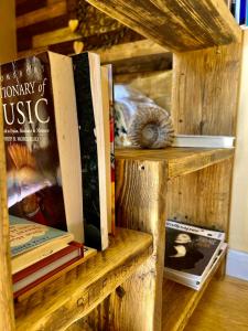 a wooden book shelf with books on it at The Vikings Retreat in Donington on Bain