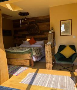 a bedroom with a bed and a chair at The Vikings Retreat in Donington on Bain
