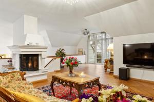 a living room with a couch and a table and a tv at Villa Muusa in Tallinn