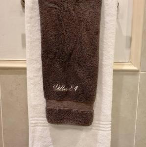 a towel hanging on a towel rack in a bathroom at Luxury Lifestyle Villa in Mossel Bay