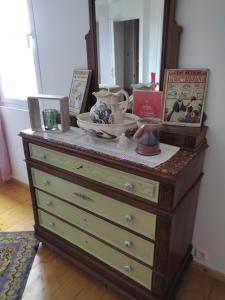 a dresser with a mirror on top of it at Chambre de Charme in Mirepoix +3 photos