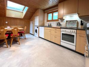 a kitchen with a table and a stove top oven at ”Heimet” im Berner Oberland in Unterbach