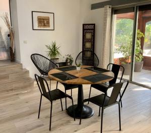 a table and chairs in a room at Villa Manoca in Boisemont +14 photos