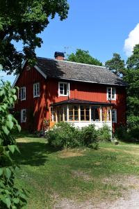 un granero rojo con techo rojo en Henneviken BnB, en Ed