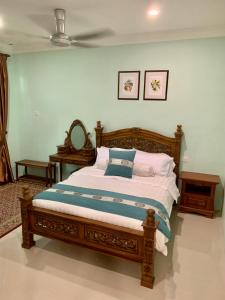 Schlafzimmer mit einem Bett und einem Deckenventilator in der Unterkunft Puncak Villa 10-20pax in Kuala Kangsar
