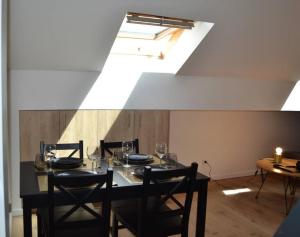 a dining room with a table with wine glasses on it at Le Cocon Filaterie in Annecy +3 photos