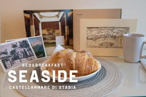 a table with a plate of bread and a cup of coffee at B&B SEASIDE in Castellammare di Stabia