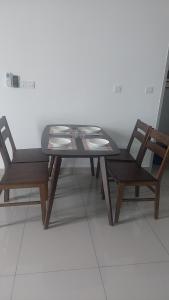 a dining table and two chairs and a table and chairs at Amber cove in Malacca