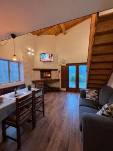 a living room with a couch and a fireplace at Piccolo Casale antica fonte in Villecollefegato