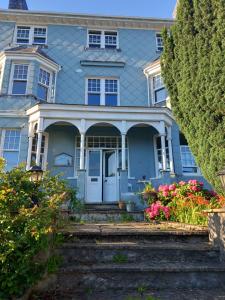 a blue house with flowers in front of it at Northampton House in Llanwrtyd Wells