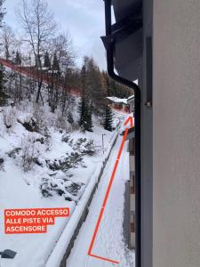 a view of a snow covered road from a train window at Appartamento sulle piste Folgarida in Folgarida